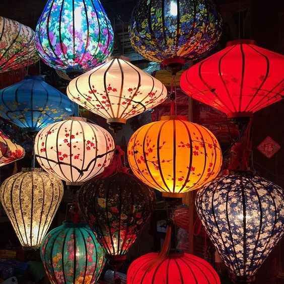 many colorful lanterns are hanging from the ceiling