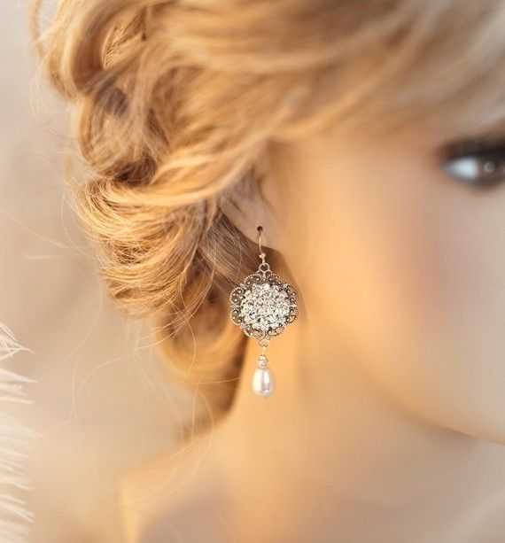 a close up of a mannequin head wearing earrings