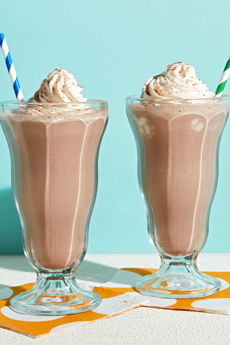 two glasses filled with ice cream on top of a table