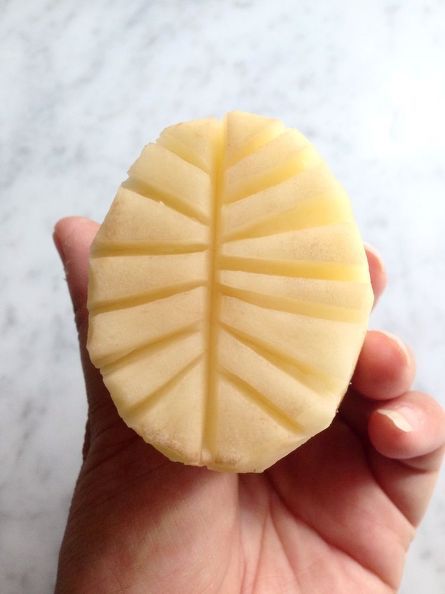 a hand holding a piece of food in it's palm - like shape on a marble surface