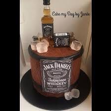 a cake made to look like a barrel with whiskey and ice cubes on top