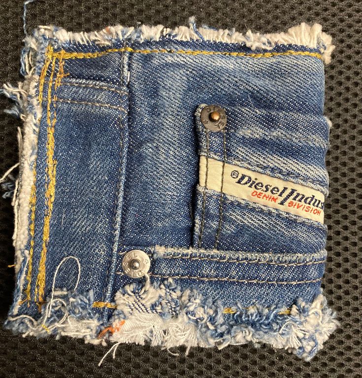 an old pair of blue jeans with torn edges