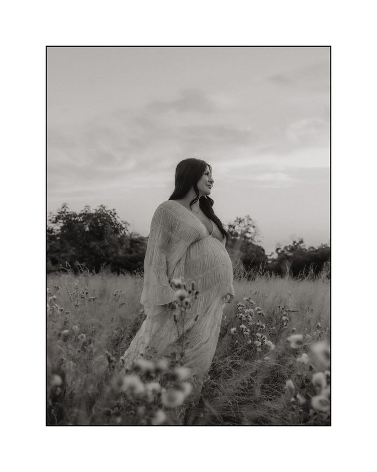 black and white photograph of a woman in a field