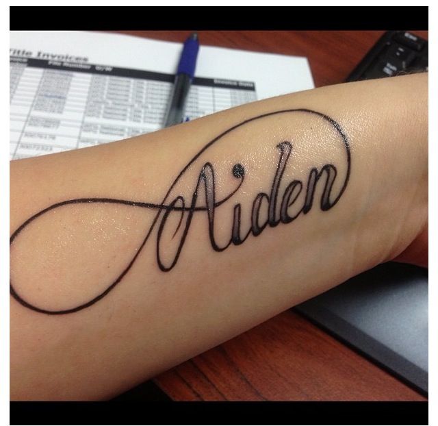 a tattoo with the word alden written in cursive writing on it's arm