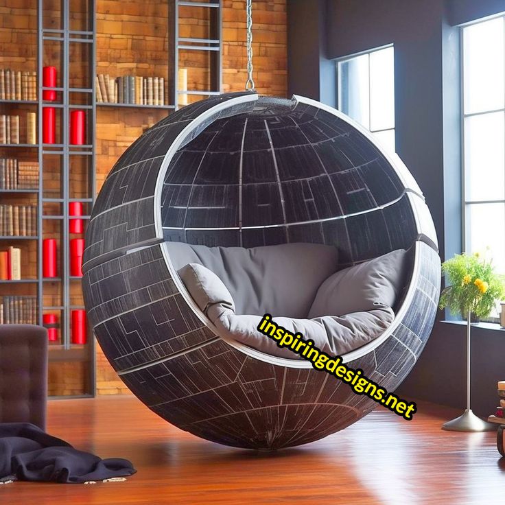 a large ball shaped chair in the middle of a room with bookshelves behind it