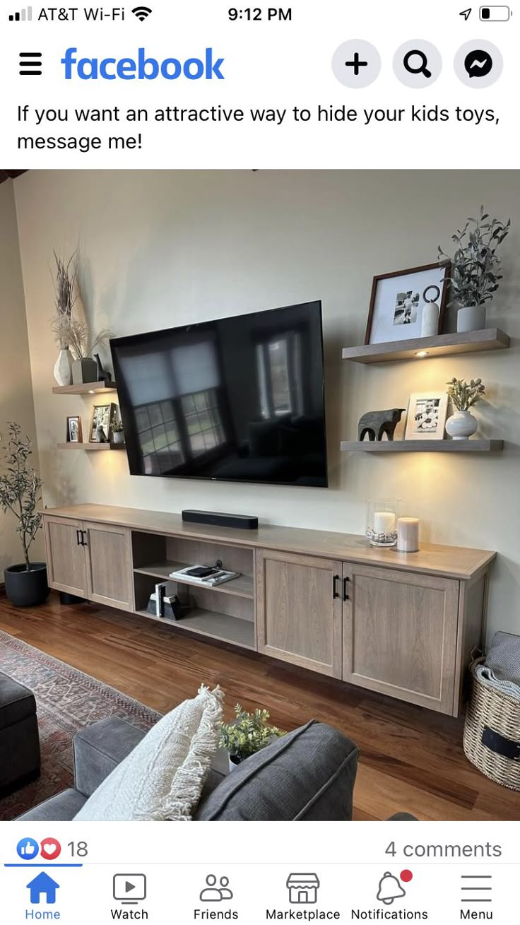 a living room with an entertainment center and large screen tv on the wall above it