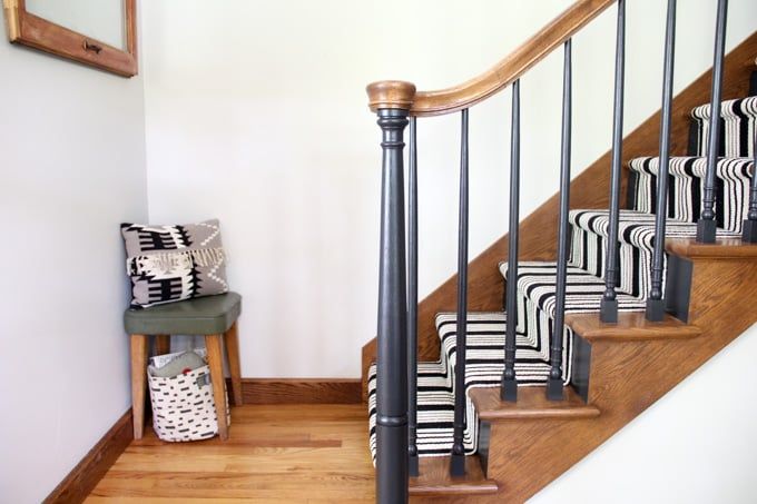 the stairs are lined with black and white pillows