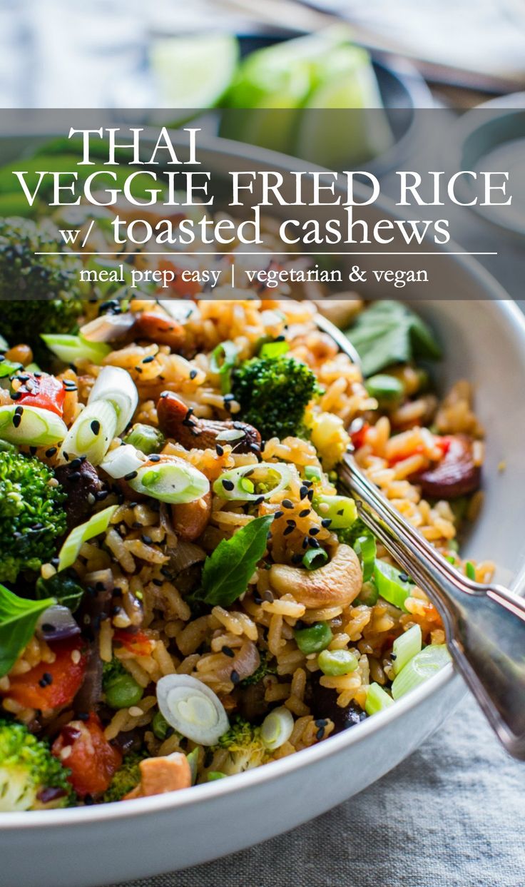 thai fried rice with vegetables and cashews in a white bowl on a table