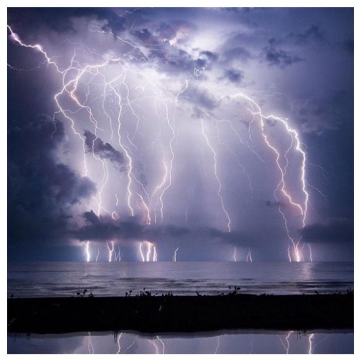 a large group of lightning strikes over the ocean