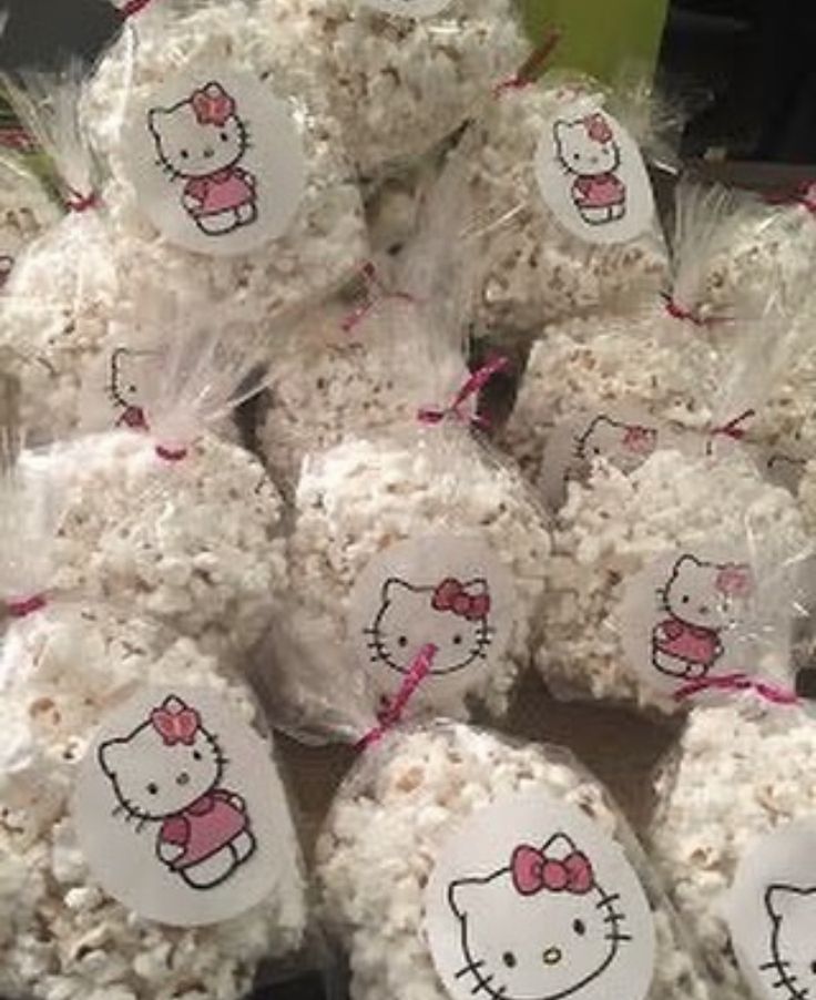 hello kitty popcorn balls are wrapped in cellophane and tied with pink ribbon for decoration