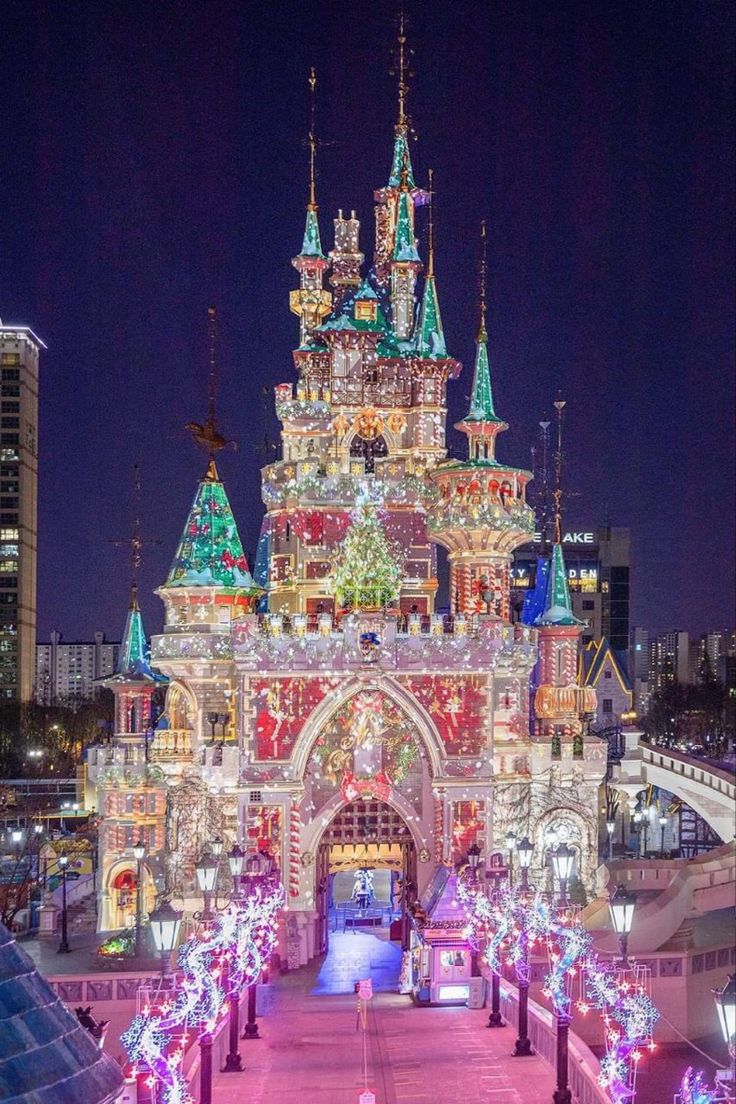 the entrance to disneyland's christmas wonderland is lit up with colorful lights and decorations