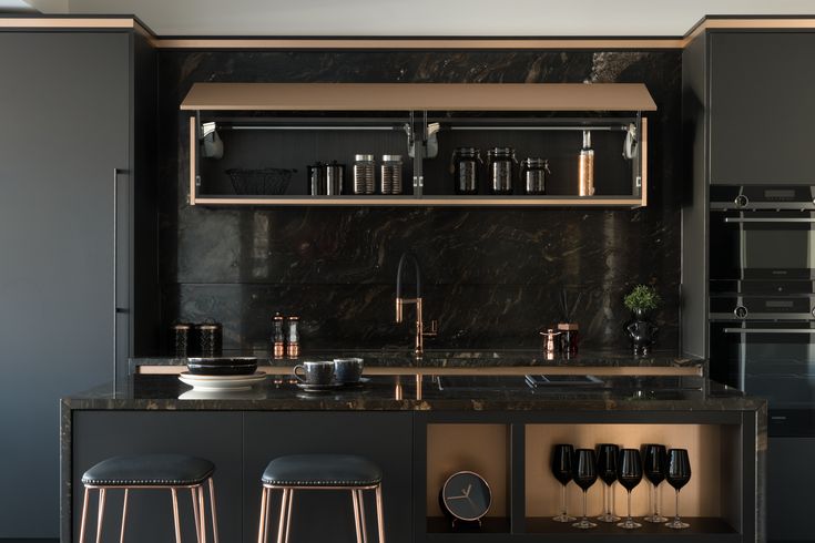 a kitchen with marble counter tops and bar stools