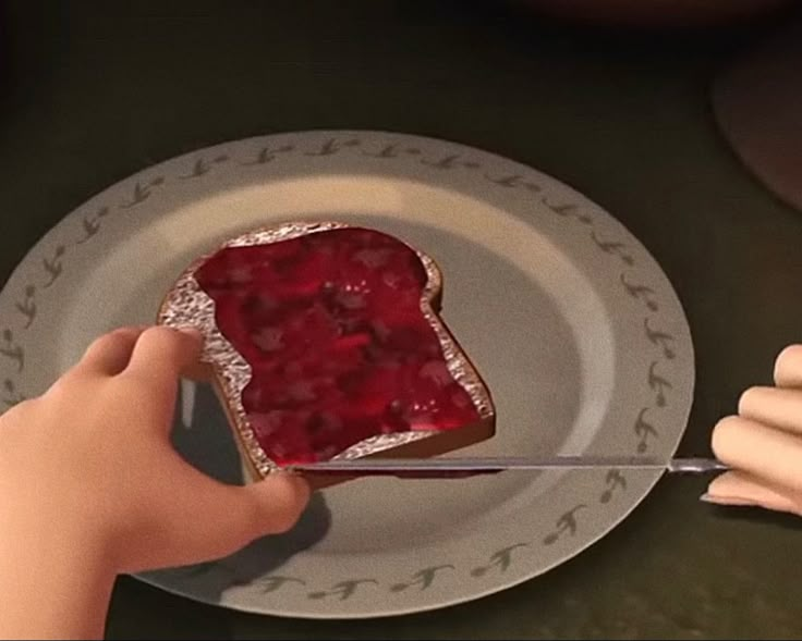 a person cutting into a piece of cake with a knife and fork