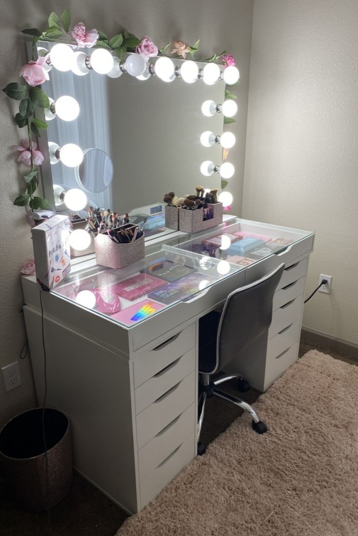 a white vanity with lights on it and a mirror in the corner next to it