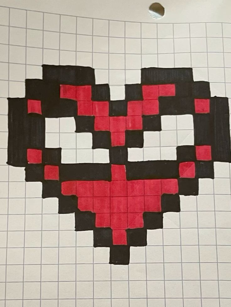 a piece of paper that has been made to look like a heart with red and black squares on it