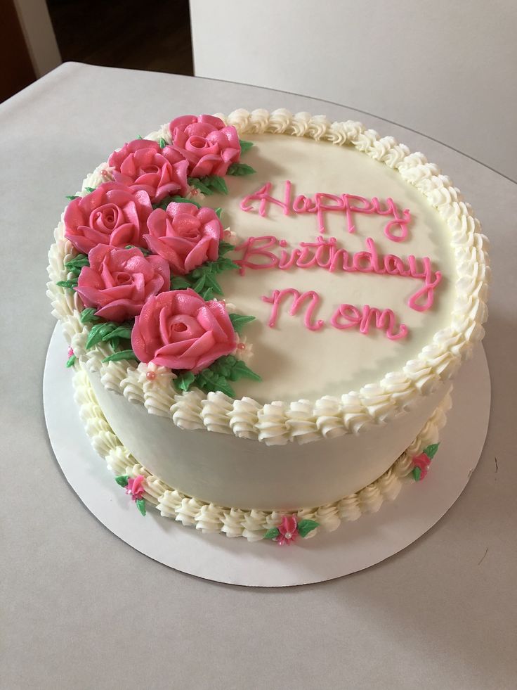 a birthday cake with pink roses on it