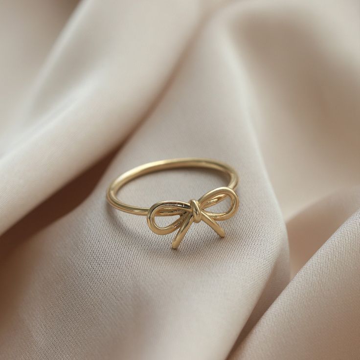 Ⓜ 14K Gold Bow Infinity Ring The bow ring in its minimal desing with the infinity symbol symbolizing innocence is one of the most beautiful gift options you can buy for yourself or your loved ones ⓂMaterials & Specifications : 14K Gold Bow Ring Ring Width : 7,21 mm (0.28 in) Ring Length : 13,61 mm (0.53 in) 3 Colours are in options. Check out our return policy for personalized products. Personalized order group All rings made to be custom made. Ring Aesthetic Minimalist, Bow Gold Ring, Cute Ring Designs, Ins And Outs List, Bow Ring Gold, Jewelry Gold Aesthetic, Hold Jewelry Aesthetic, Gold Rings Dainty, Cute Simple Rings