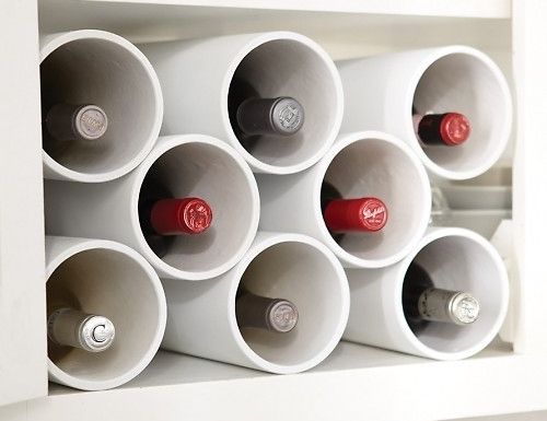 a bunch of wine bottles that are in a shelf