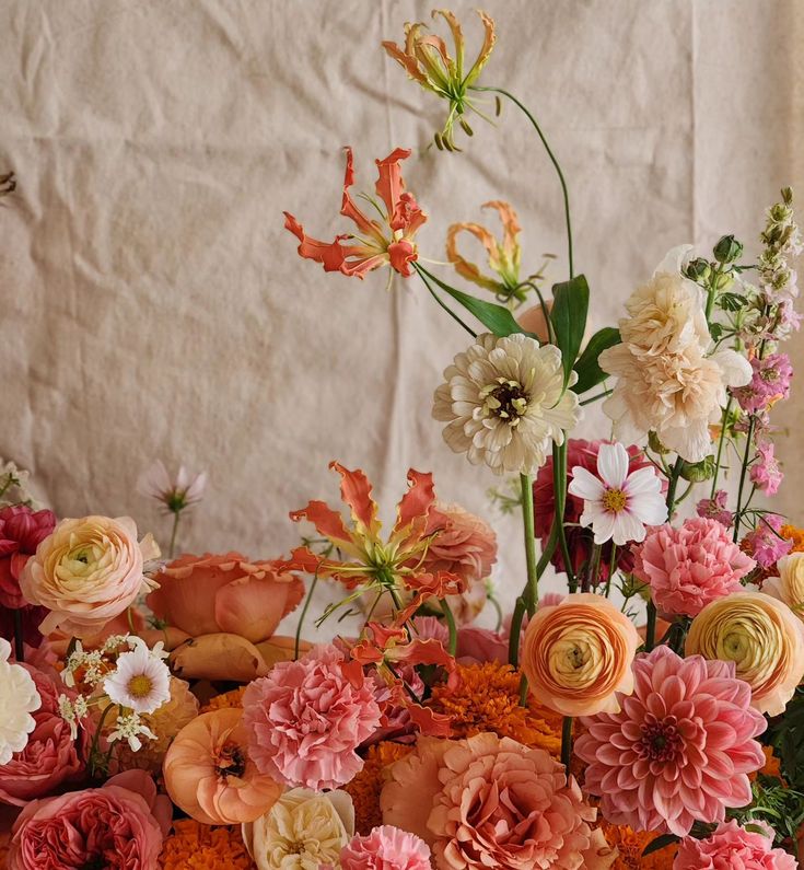 a vase filled with lots of different colored flowers