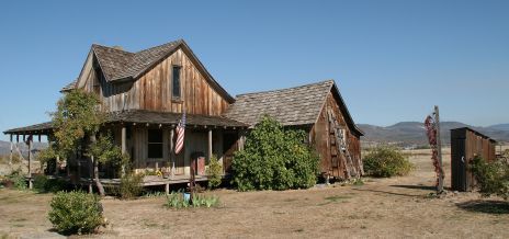 an old wooden house in the middle of nowhere