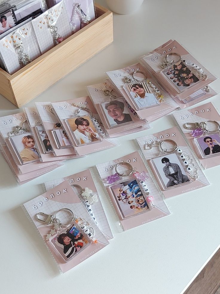 a bunch of pictures and keychains are on the table next to each other