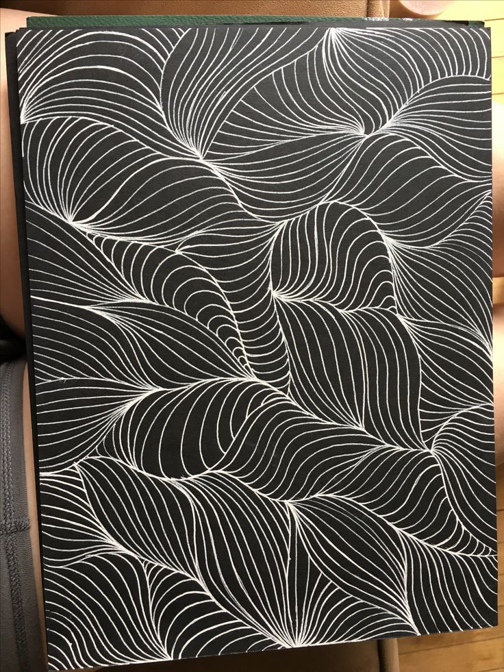 a black and white painting with wavy lines on the back of it's frame