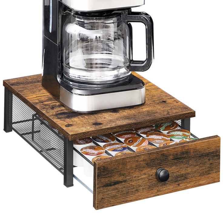 a coffee maker sitting on top of a wooden drawer