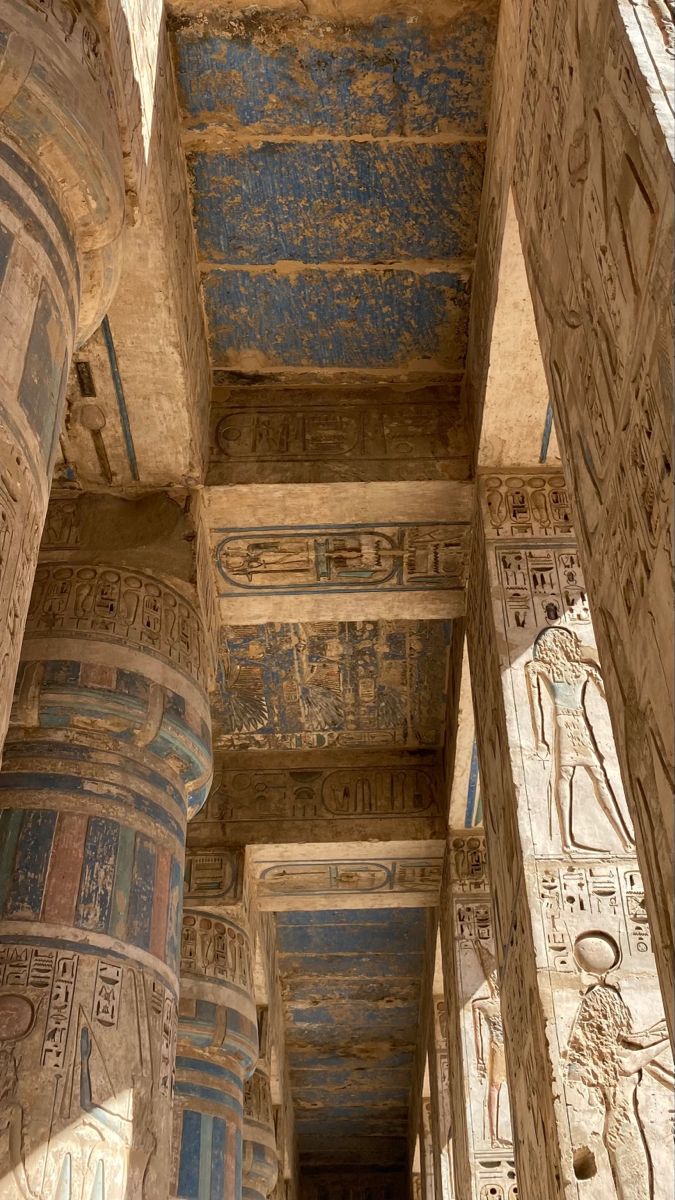 the interior of an ancient egyptian temple with painted columns