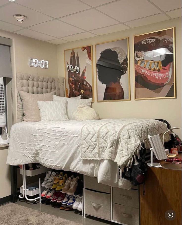 a bedroom with two pictures on the wall