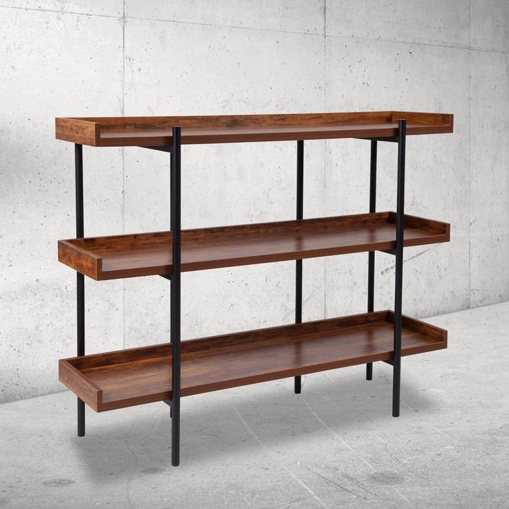 a wooden shelf with black metal legs and two shelves on each side, against a concrete wall