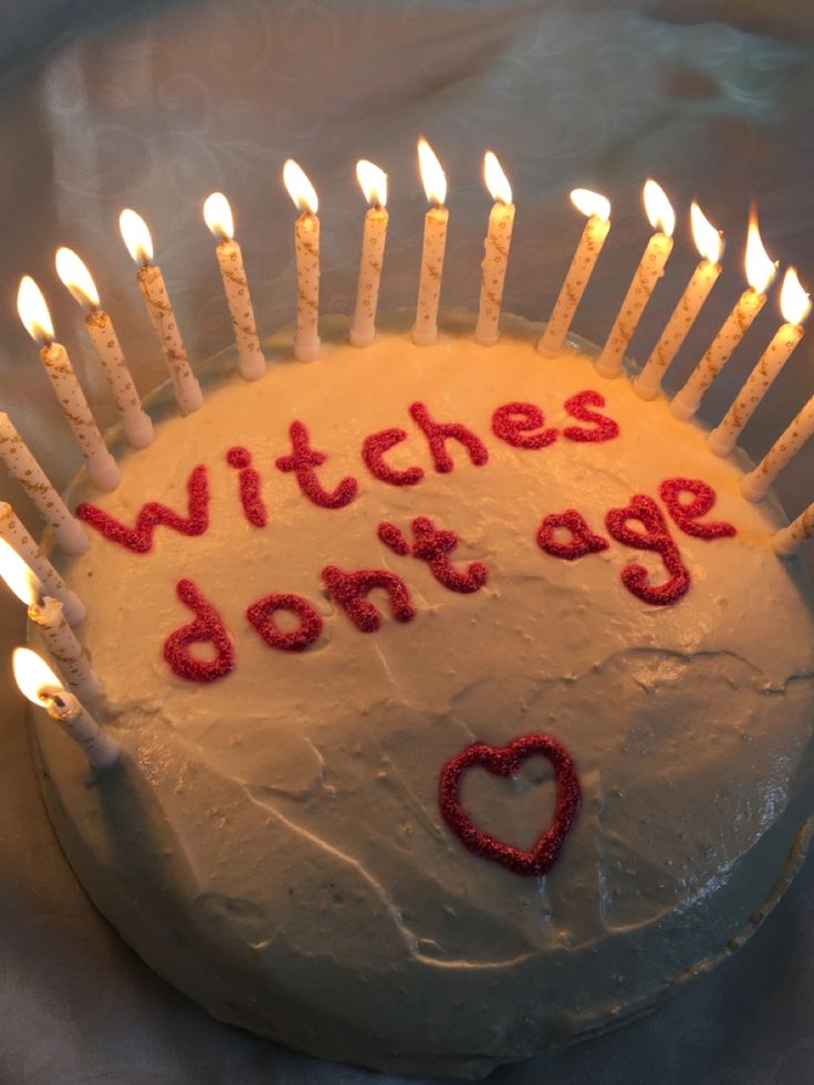 a birthday cake with candles that say witches don't age