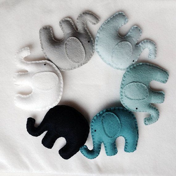 four felt elephants are arranged in a circle