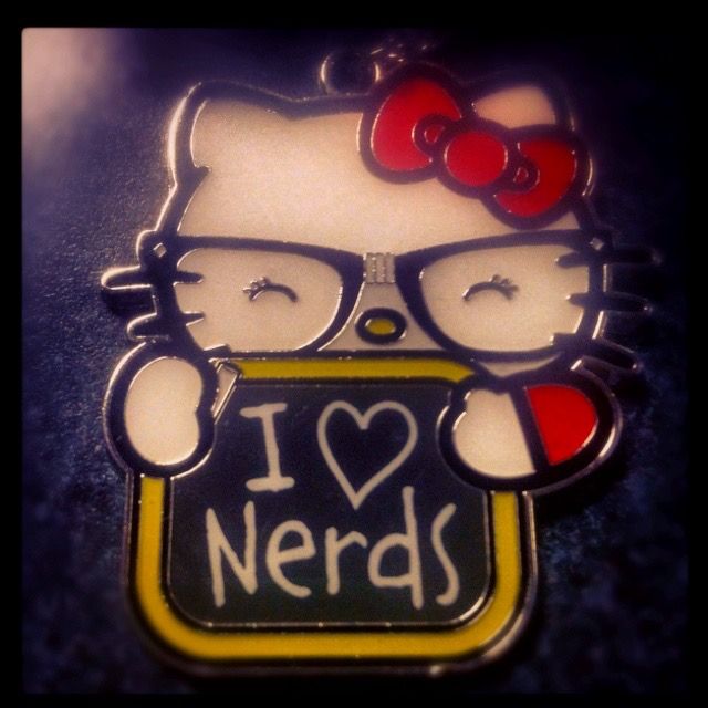 a hello kitty pin that says i love nerds