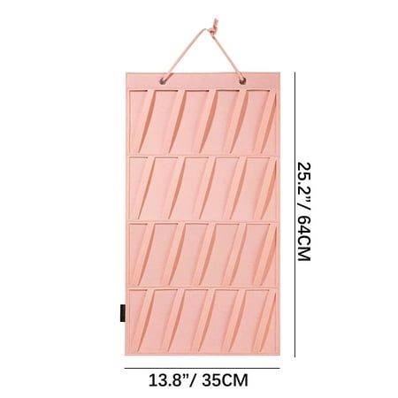 a pink wall hanging on the side of a white wall