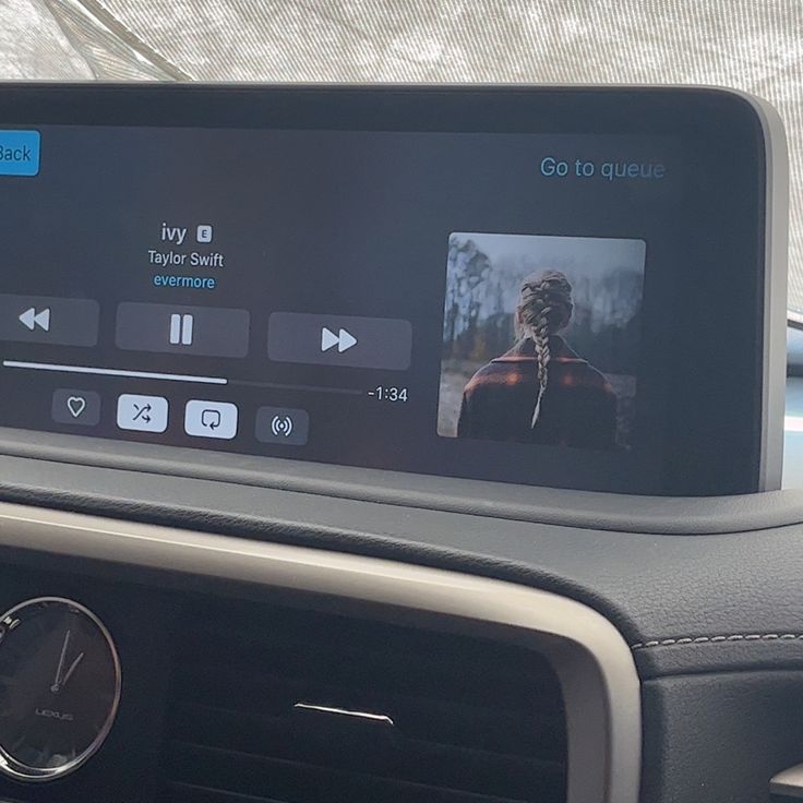 the dashboard of a car with an audio player on it's display and other electronic devices