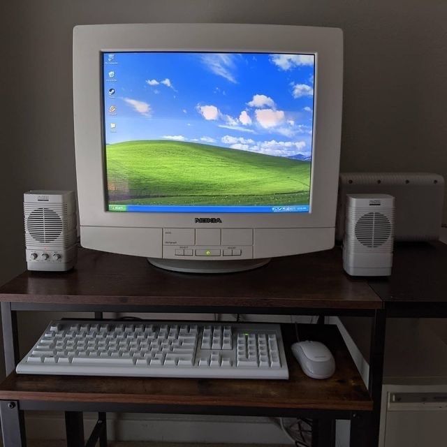 a desktop computer sitting on top of a wooden desk