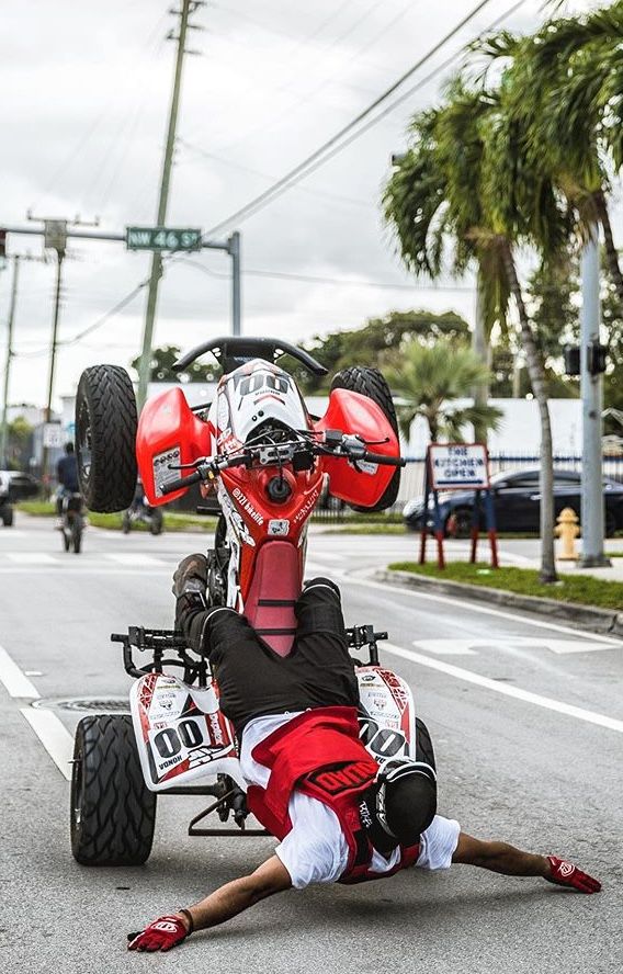 a person on the ground in front of a motorcycle