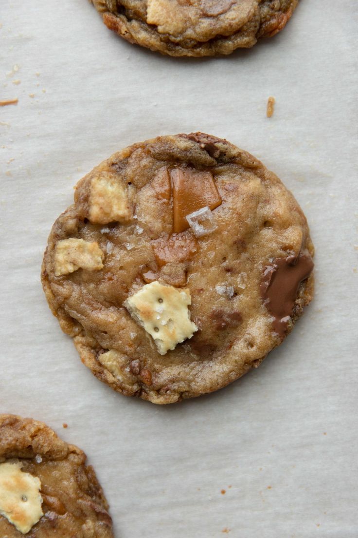 three cookies with chocolate chips and butter on top