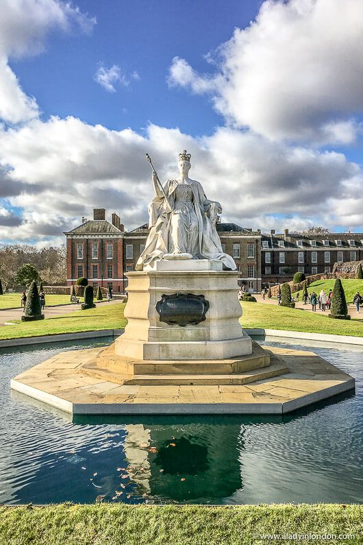 a statue in the middle of a pond