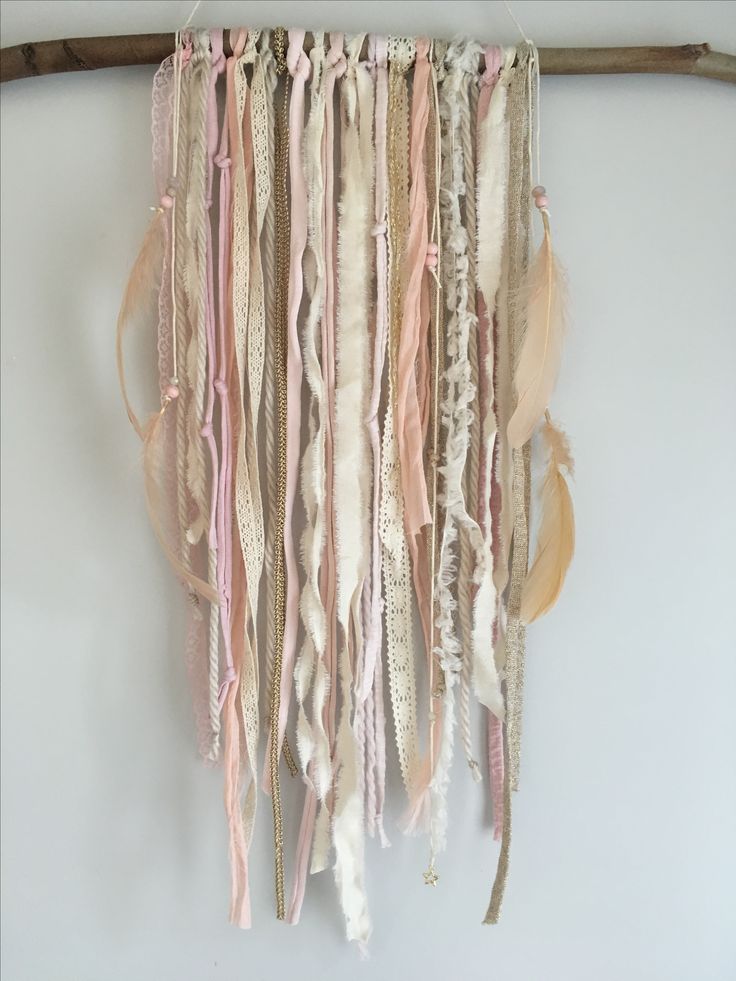 a wall hanging made out of fabric and feathers