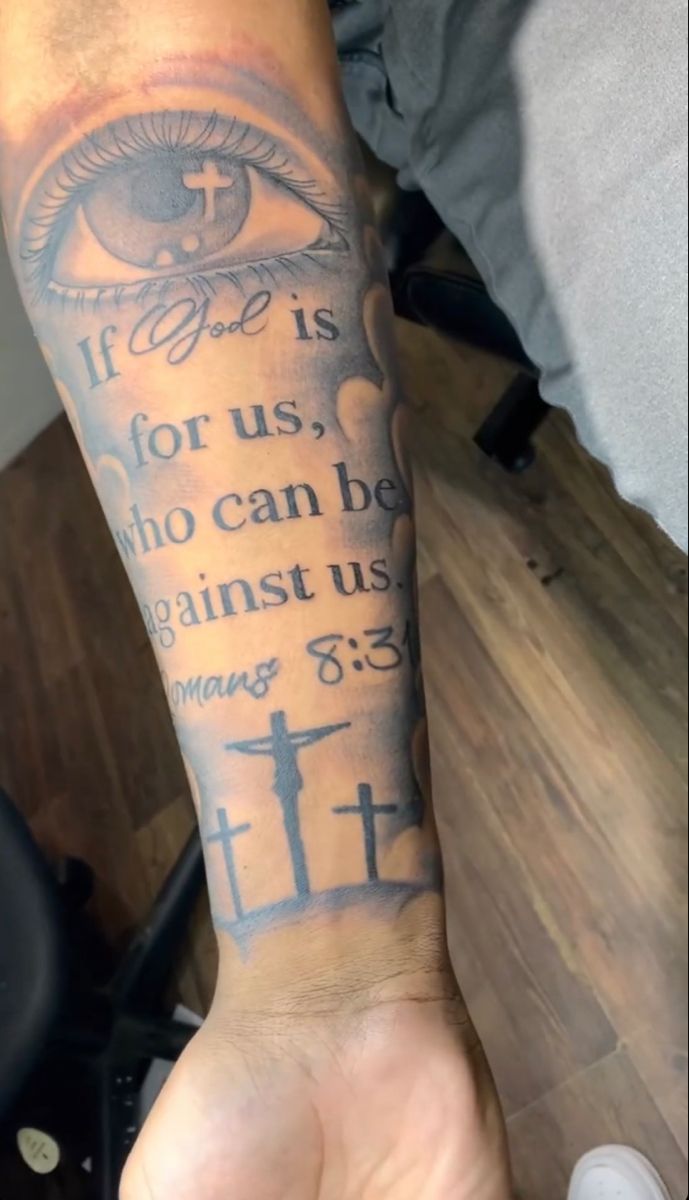 a person with a tattoo on their arm that says if god is for us, who can be against us