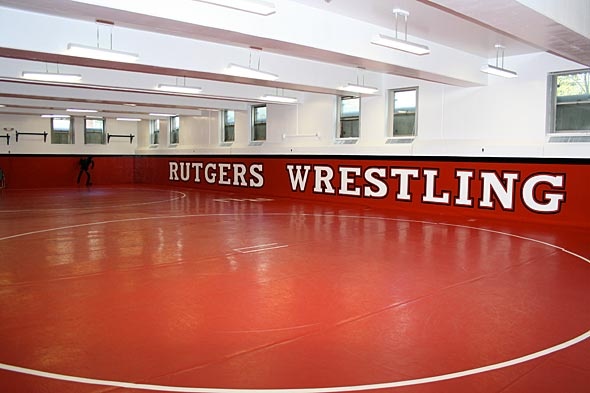 an indoor wrestling ring with the words ruggers wrestling on it's side wall