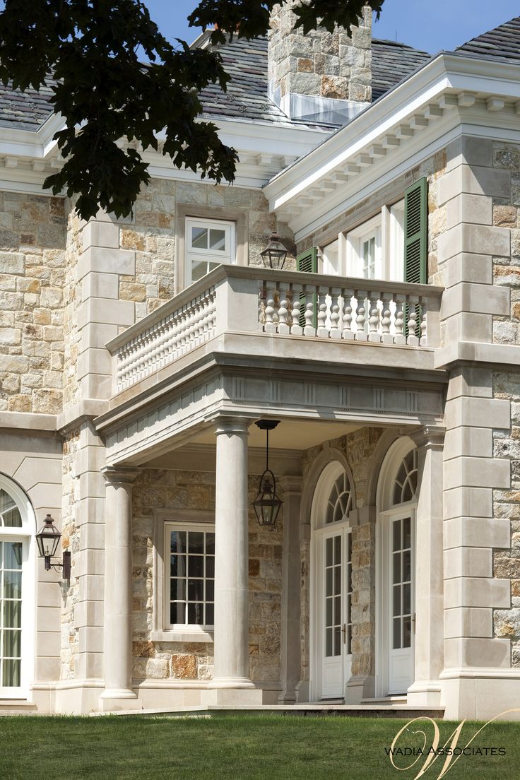 a large stone house with columns and windows