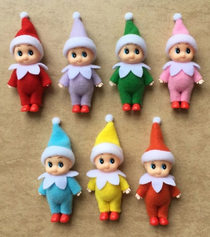 six small elf dolls sitting next to each other