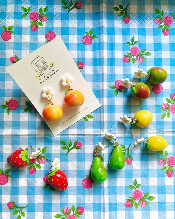 some fruit are laying on a blue and white checkered tablecloth