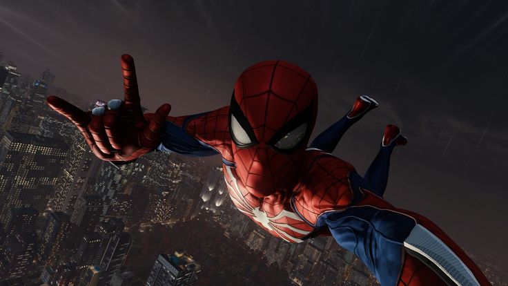 spider - man flying in the air over a city at night with his hands up