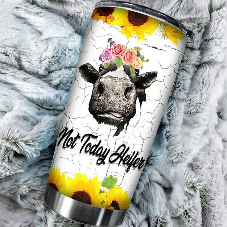 a cow with sunflowers and roses on it's head is next to a blanket