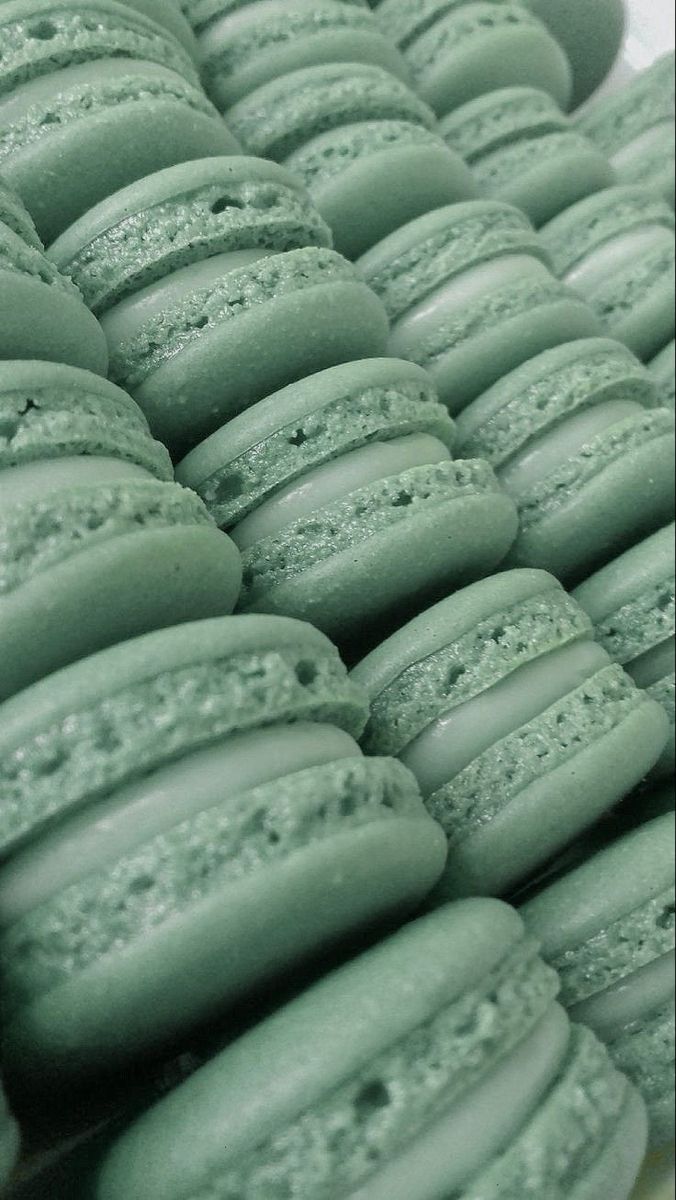 green macaroons are stacked on top of each other in this close up photo