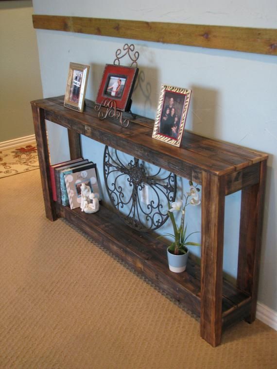 a wooden shelf with pictures and frames on it