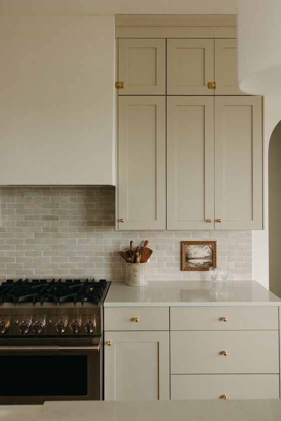 a white kitchen with an oven, stove and cabinets in the corner by the counter